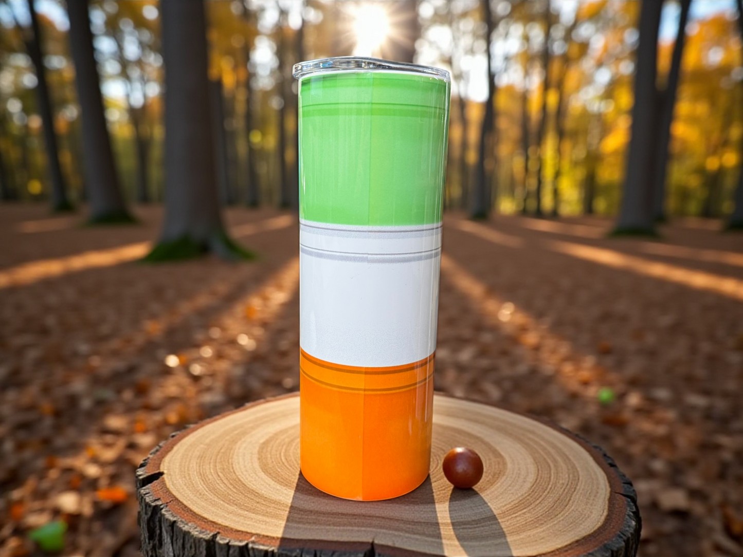 Colorful tumbler on a wooden stump in a forest setting