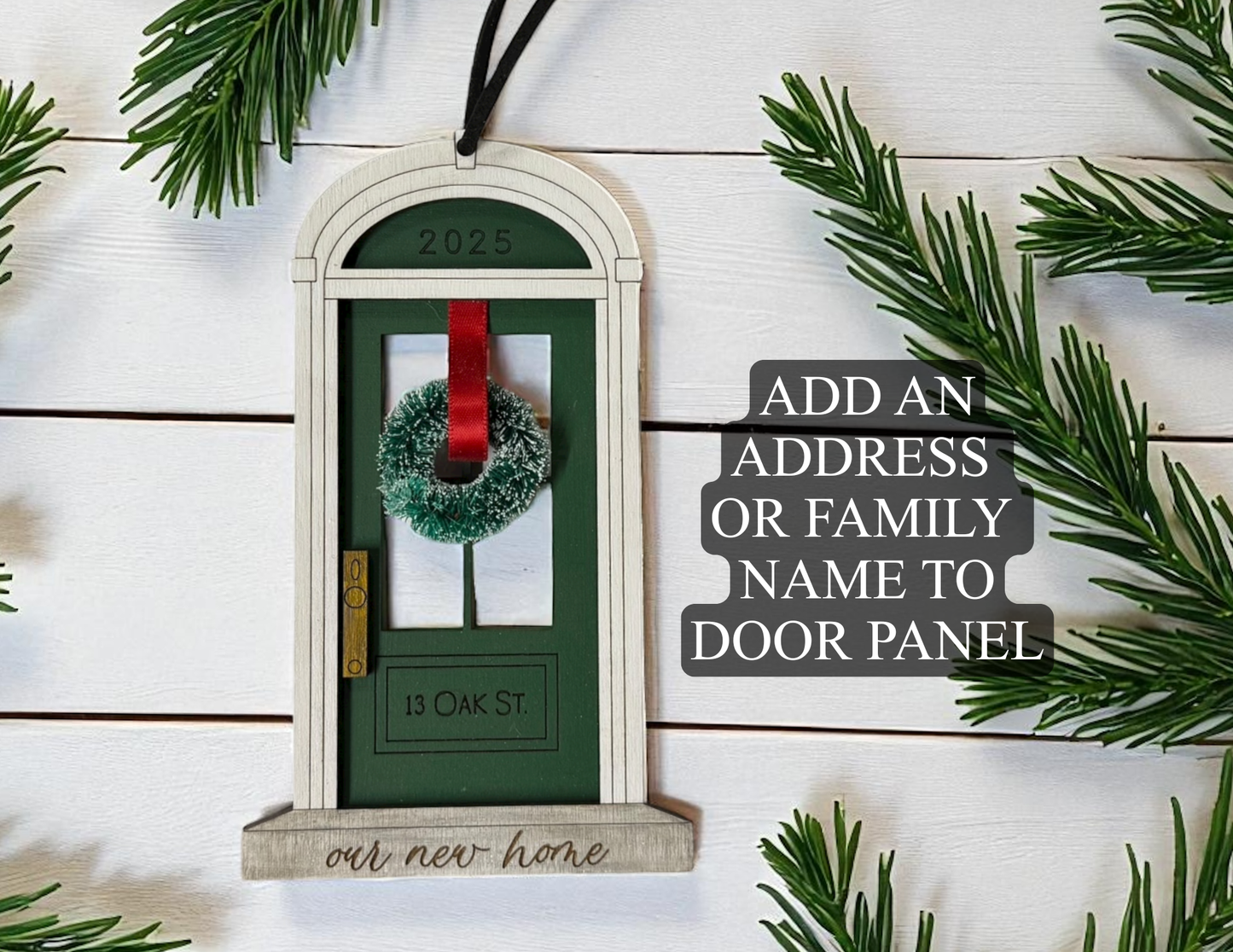 Decorative door with wreath and red ribbon on a wooden background with Christmas tree branches.